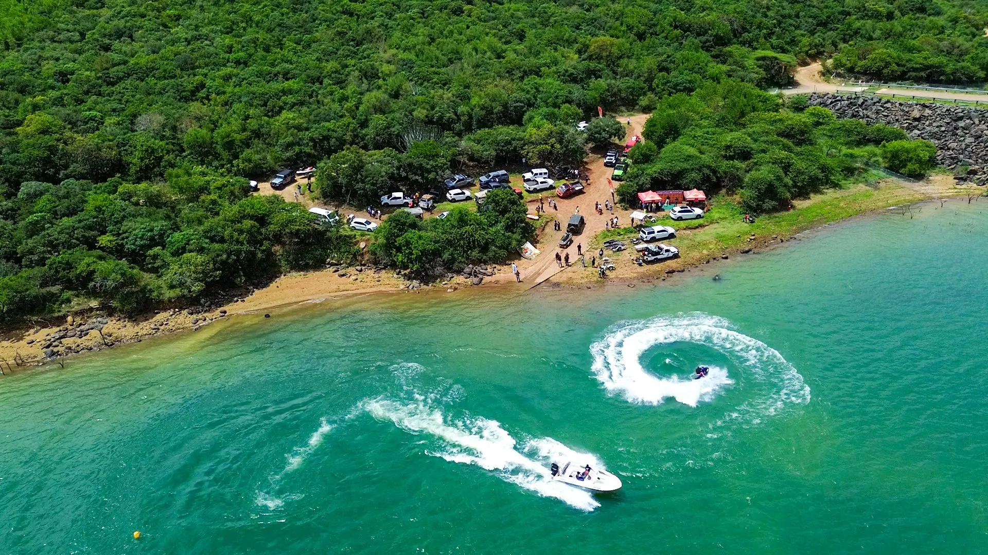 Aerial view of boats leaving white wakes near the shore