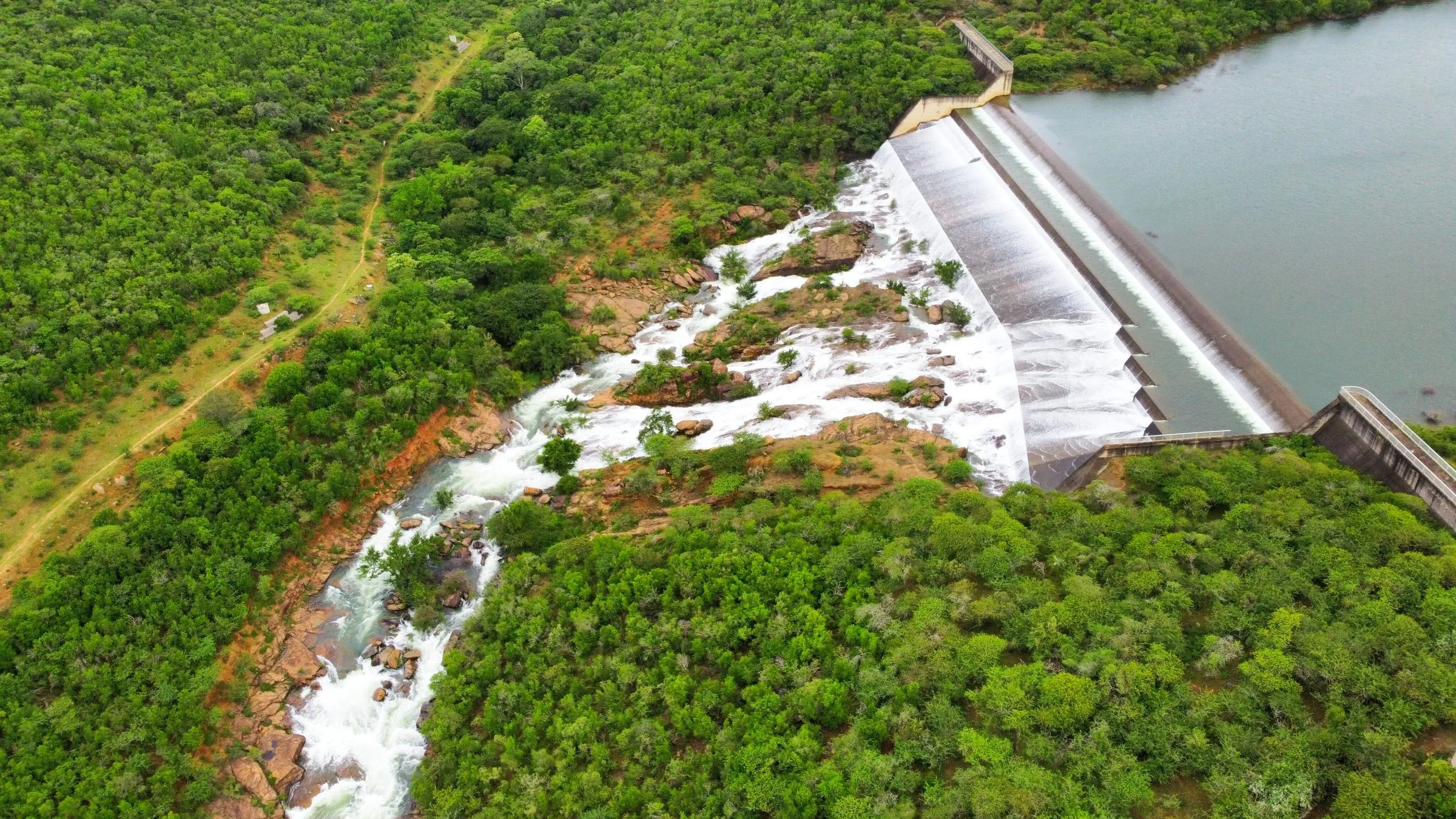 Aerial view of water spilling over the dam wall