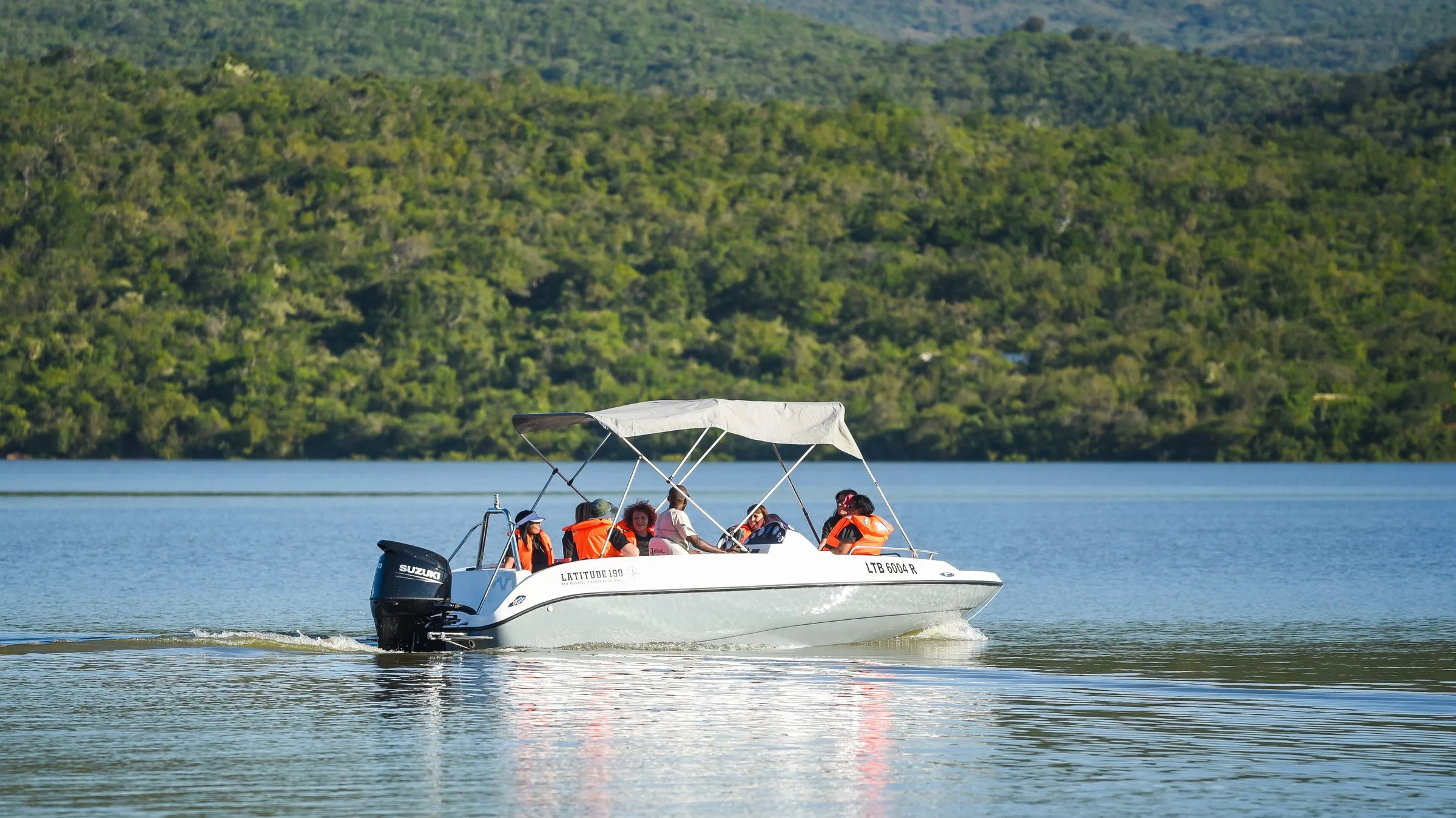 The Rim Cruise boat crossing the dam with guests on board