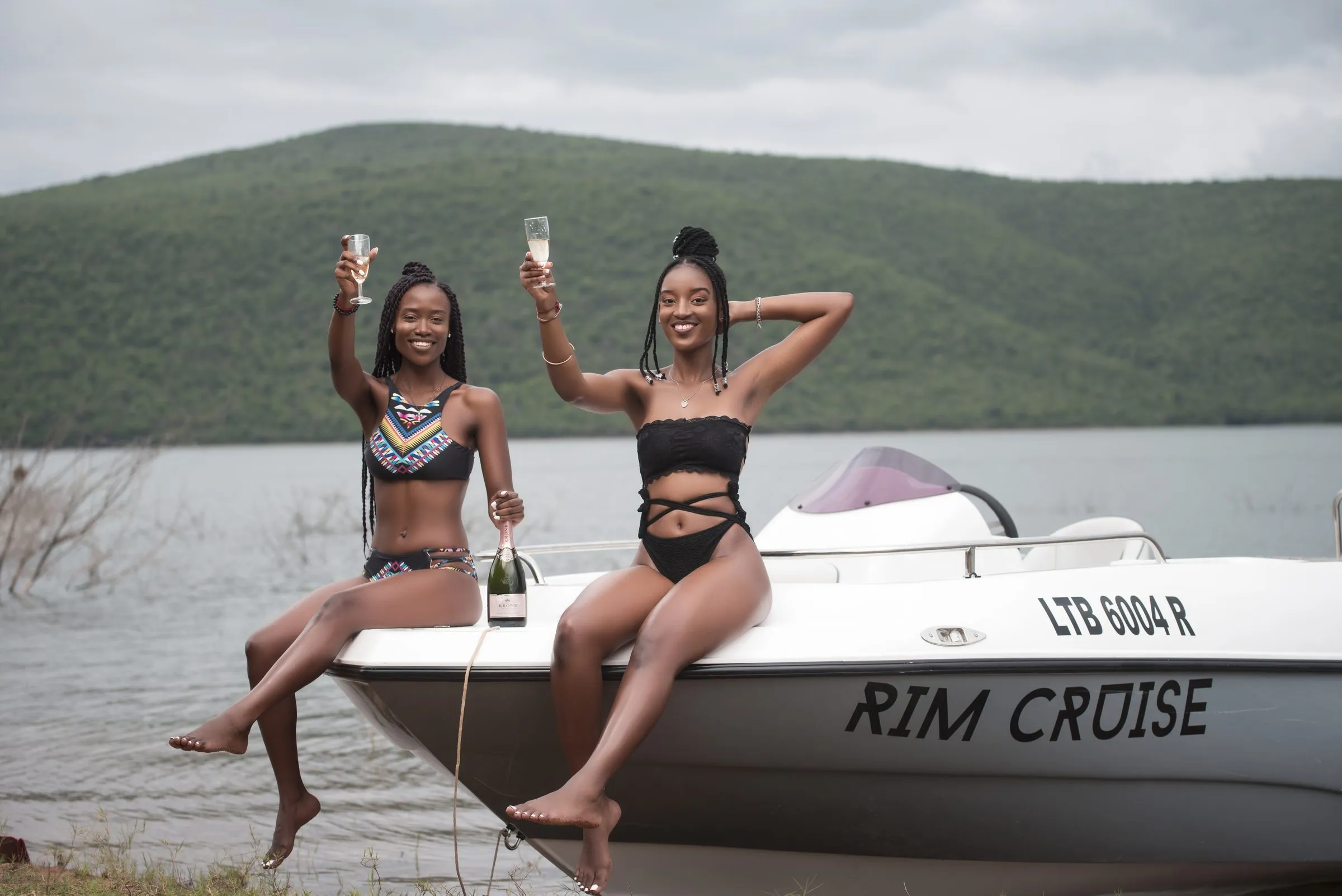 Two friends toasting on the bow of the Rim Cruise boat