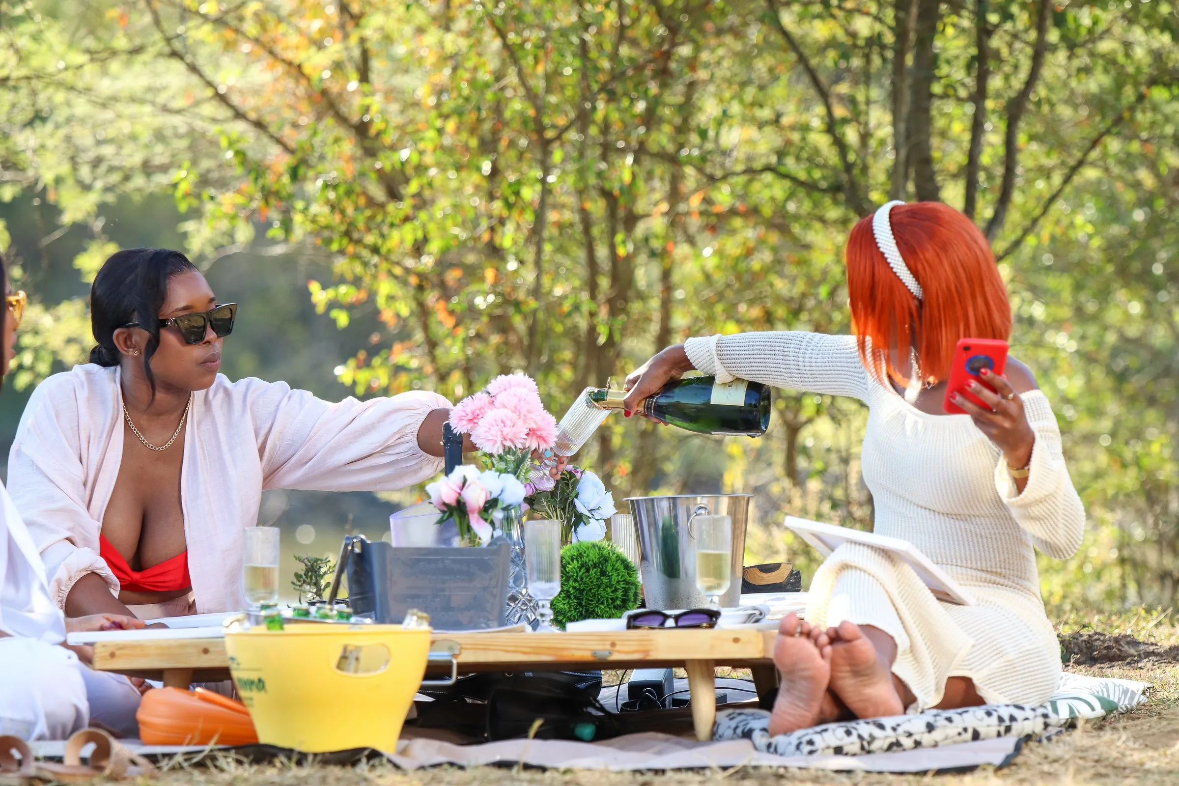Pouring drinks at a lakeside picnic