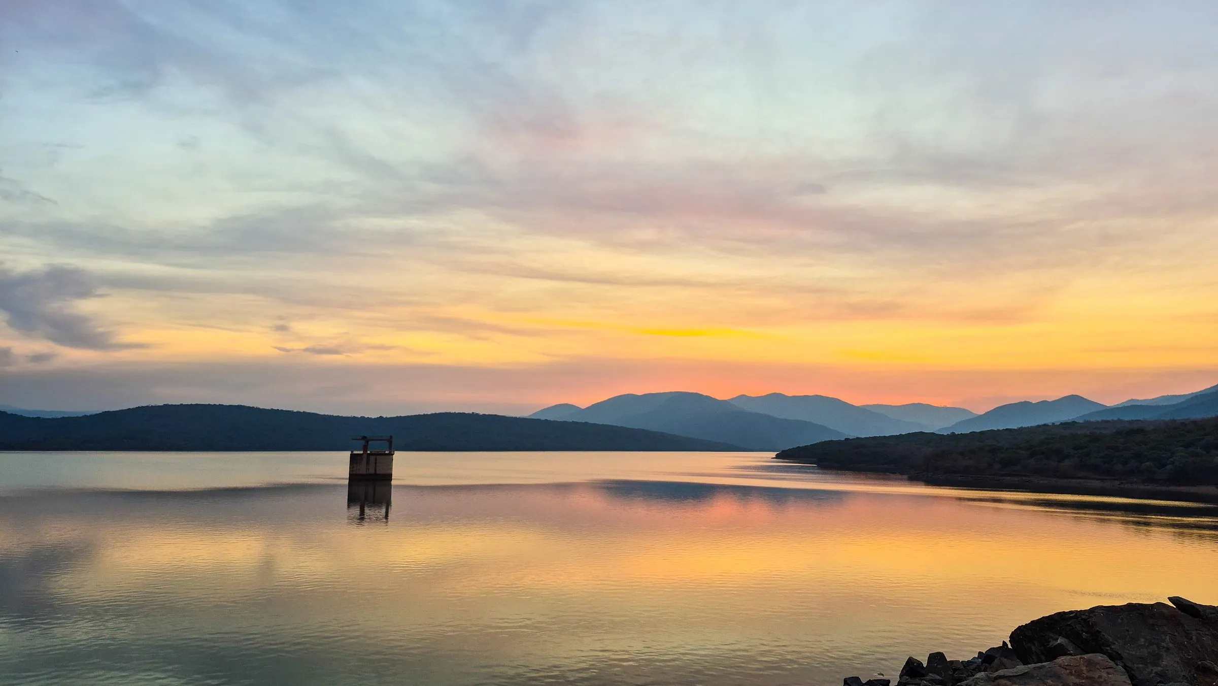 Sunset over the dam with the intake tower on the horizon